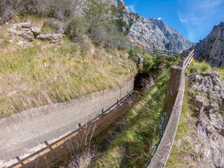 Aqueduct built to supply water to the hydroelectric exploitation in the Central Camarmena. The Cares Route in the heart of Picos de Europa National Park, Cain-Poncebos, Asturias, Spain.