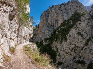 The Cares Route in the heart of Picos de Europa National Park, Cain-Poncebos, Asturias, Spain. Narrow and impressive canyon between cliffs, bridges, caves, footpaths and rocky mountains.