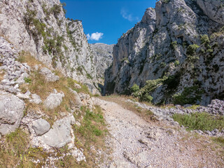 The Cares Route in the heart of Picos de Europa National Park, Cain-Poncebos, Asturias, Spain. Narrow and impressive canyon between cliffs, bridges, caves, footpaths and rocky mountains.