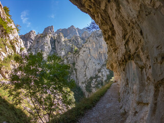 The Cares Route in the heart of Picos de Europa National Park, Cain-Poncebos, Asturias, Spain. Narrow and impressive canyon between cliffs, bridges, caves, footpaths and rocky mountains.