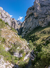 The Cares Route in the heart of Picos de Europa National Park, Cain-Poncebos, Asturias, Spain. Narrow and impressive canyon between cliffs, bridges, caves, footpaths and rocky mountains.