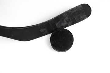A fragment of a hockey stick and puck on a white background