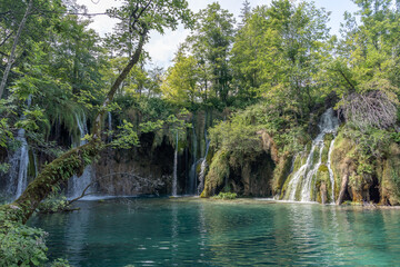 Plitvice, Croatia - Aug 11, 2020: Waterfall cascade in the lakes area in summer
