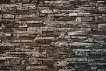 A stone wall with slate stones