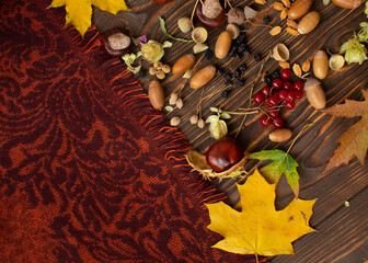 Vintage Autumn border and fallen leaves on old wooden background.