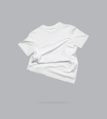 White flying cotton T-shirt isolated on gray background. Clean white t-shirt for women or men. Unisex T-shirt. Branding clothes front view. Mock up for your design