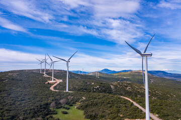 Wind turbines, renewable energy on a green hill. Wind farm