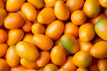 Top view of bunch of fresh kumquats in the organic food market.