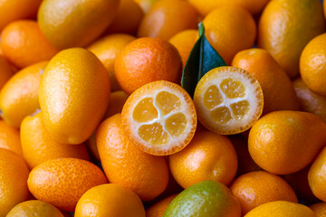 Top view of bunch of fresh kumquats in the organic food market.