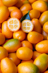 Top view of bunch of fresh kumquats in the organic food market.