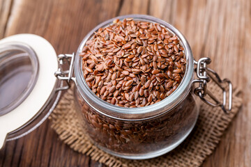 Linum usitatissimum is scientific name of Brown Flax seed. Also known as Linseed, Flaxseed and Common Flax. Pile of grains, isolated white background.