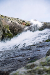Vertical shot of a river stream on a gloomy day in Spain