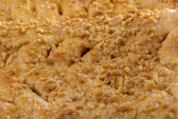 Italian cantuccine cookies with peanuts. Close-up of a cookie. Abstract background.
