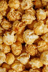Popcorn in caramel glaze close-up as a background.