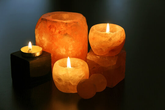 Himalayan salt candles holders on the dark desk