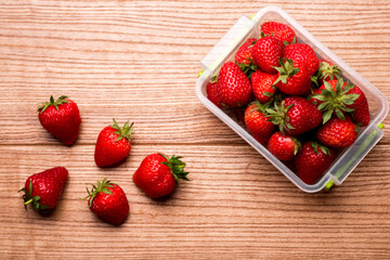 Fresh pleasant strawberries on a wooden table. Strawberry juice