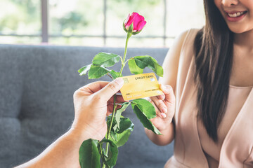 Blurred soft images of attractive woman picking mock up credit cards But not picking roses flower...