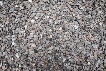 Stone pattern abstract ravel texture small stones, little rocks, pebbles in many shades of grey, white, brown, pink colour in close-up for granite texture background