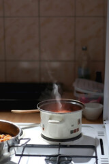 Cooking tomato sauce at home. Selective focus.