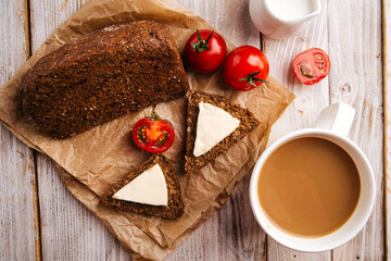 Top view on flourless diet grain bread with cheese and coffee on the wooden table