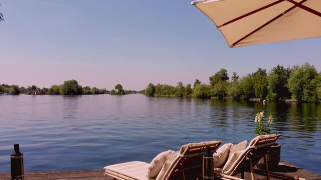 Typical landscape in the Netherlands. Tanning beds on a Dutch private islands on big blue lake. Many tourist travel here to drive a boat and enjoy the calm and quiet nature. Vinkeveen, Utrecht 11