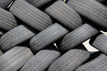 closeup of neatly stacked up used tires