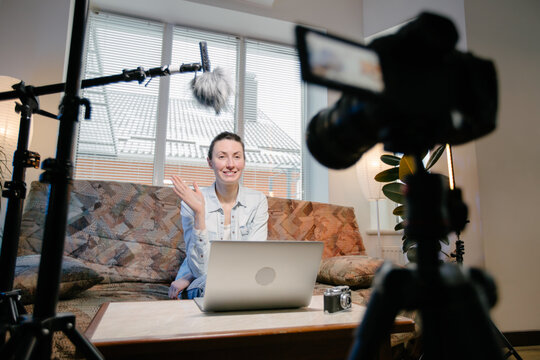 Woman blogger or vlogger streamming online on social media to her subscribers.