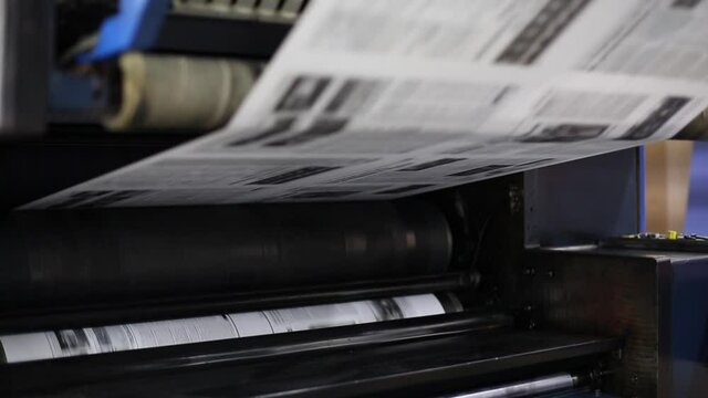 The process of printing a newspaper with automated machines 