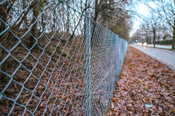 A metal fence on the side of the road