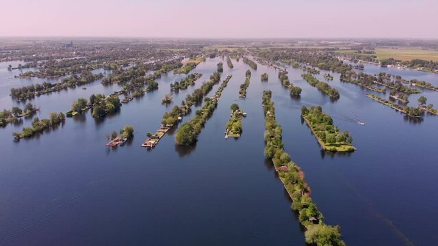 Typical landscape in the Netherlands. Artificial Dutch private islands on big blue lake. Many tourist travel here to drive a boat and enjoy the calm and quiet nature. Vinkeveen, Utrecht 11