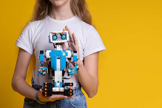 Minsk, Belarus. January 2021. A teenage girl holds Lego Boost robot. It is a best toy for kids. STEM and STEAM education. DIY. AI.
