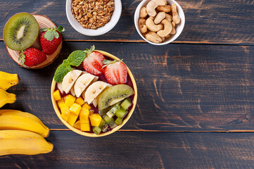 .Brazilian açaí in a bowl accompanied by tropical fruits. Fruit of the Amazon. Copy space