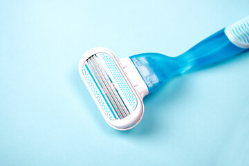 Women razor isolated on a blue background. Close-up. Beauty concept.