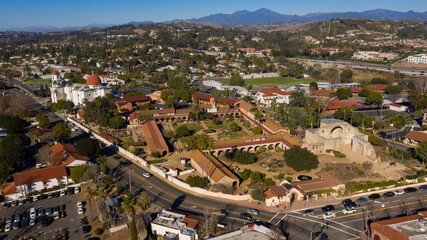 Fototapeta na wymiar Daytime aerial view of the Spanish Colonial era mission and surrounding city of downtown San Juan Capistrano, California, USA. 