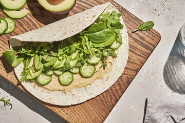 Vegetarian tortilla with hummus and green vegetables