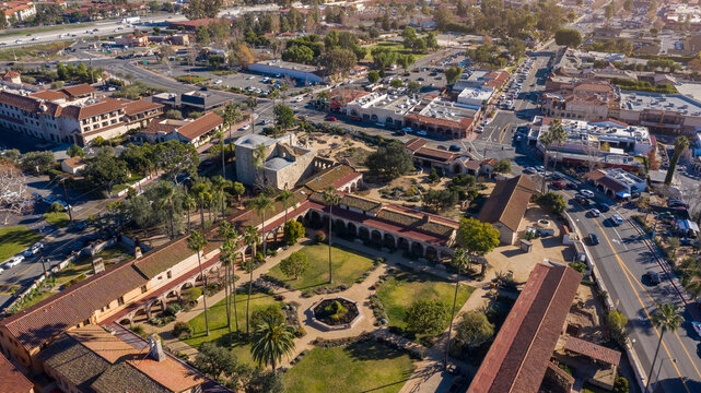 Daytime aerial view of the Spanish Colonial era mission and surrounding city of downtown San Juan Capistrano, California, USA. 