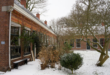 Ancient courtyard in the historic city centre of Groningen with snow in the winter