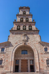 Cangas de Onis, Spain - September 4, 2020: The Church of Our Lady of the Assumption of St. Mary (Iglesia de Nuestra Señora de la Asunción de Santa María) with tower and 6 bells.