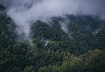 little abandoned house minimalism in the woods alone dark moody cloudy cloouds stone swiss house italien house italy