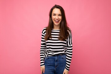 Portrait of positive cheerful fashionable woman in casual clothes isolated on pink background with copy space
