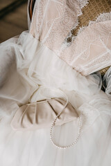 Closeup of wedding bridal details. Small elegant purse on wedding dress.