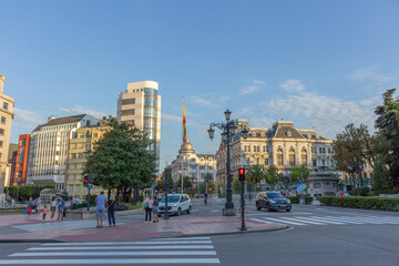 Naklejka premium Oviedo, Principality of Asturias, Spain - September 4, 2020: Downtown cityscape, Plaza de la Escandalera, centered fountain and the General Junta of the Principality of Asturias.