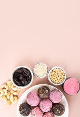 Ingredients Homemade pink matcha dragon fruit energy balls, top view, healthy sweets made of nuts and date, prunes, cashew nuts, Pine nuts. Vegeterian diet candy brain sustainable food. Copy space