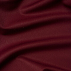 Smooth fabric texture with folds and wawes. Close up silk background