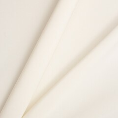 Smooth fabric texture with folds and wawes. Close up silk background