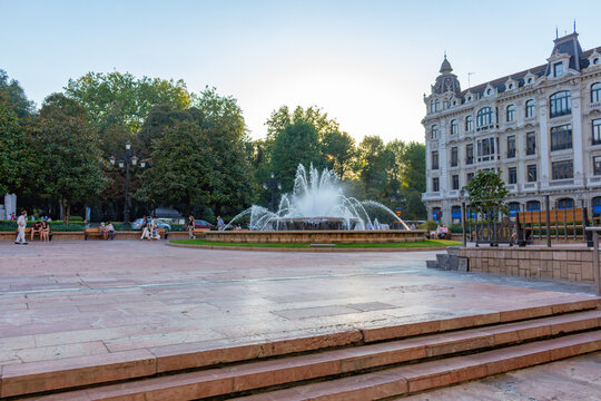 Oviedo, Principality of Asturias, Spain - September 4, 2020: Downtown cityscape, Plaza de la Escandalera, centered fountain, and the building with eclectic architecture called Casa Conde.