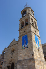 Puebla de Sanabria, Spain - September 6, 2020: Bell tower of Santa María del Azogue church (Iglesia de Nuestra Senora del Azogue) is a pretty village church that was first built in the 12th century.