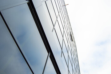 Fototapeta na wymiar Side view of a glass building with a blue sky