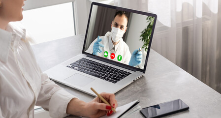 Fototapeta na wymiar Young Female Doctor Video Chatting On Laptop In Clinic