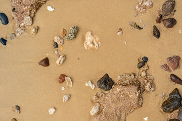 Fototapeta na wymiar Pebbles on the sandy beach